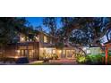 Two-story house exterior with backyard and lighting at 1827 Baywood Dr, Sarasota, FL 34231
