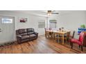 Bright dining area with hardwood floors, wooden table, and leather couch at 2343 Prospect St, Sarasota, FL 34239