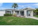Charming light blue house with carport, well-maintained lawn, and landscaping at 2343 Prospect St, Sarasota, FL 34239