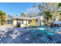 Spacious patio with a teal table and chairs, overlooking the pool at 563 Juan Anasco Dr, Longboat Key, FL 34228