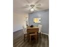 Bright dining area with light blue accent wall and wood table at 601 N Hercules Ave # 1403, Clearwater, FL 33765
