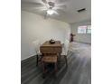 Dining area features wood table and chairs, gray flooring and ceiling fan at 601 N Hercules Ave # 1403, Clearwater, FL 33765