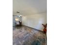 Living room with gray patterned rug and a large, neutral colored wall at 601 N Hercules Ave # 1403, Clearwater, FL 33765