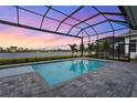 Relaxing pool and spa with a screened enclosure and sunset views at 8328 Sea Glass Ct, Sarasota, FL 34240