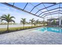 Enjoy the lake view from this screened pool and patio at 8328 Sea Glass Ct, Sarasota, FL 34240