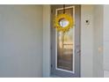 Gray front door with glass panels and a yellow wreath at 8755 Dolomite Ave, North Port, FL 34287