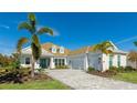 White house with gray roof, two-car garage, and palm trees at 16511 Cornwall Ln, Bradenton, FL 34202