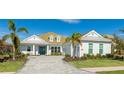 White house with gray roof, two-car garage, and landscaping at 16511 Cornwall Ln, Bradenton, FL 34202