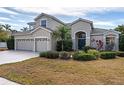 Two-story house with a three-car garage and manicured lawn at 1743 Pinyon Pine Dr, Sarasota, FL 34240