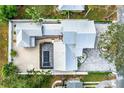 Aerial view showing a modern home with a pool and a large paved driveway at 2326 Gull Ln, Sarasota, FL 34237