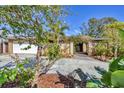 Inviting home exterior features lush landscaping and a paved driveway at 2961 Homasassa Rd, Sarasota, FL 34239