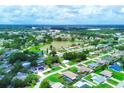 Aerial view showing the community, a central lake and surrounding homes at 300 Coral Rd, Venice, FL 34293