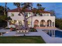 Elegant backyard showcasing the pool, covered patio, outdoor dining area, and lush landscaping of this stunning estate at 4311 Bay Shore Rd, Sarasota, FL 34234