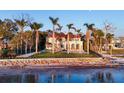 Spectacular waterfront estate with lush landscaping, pool, and outdoor dining area overlooking the serene bay at 4311 Bay Shore Rd, Sarasota, FL 34234