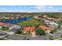 Aerial view of a beautiful home in a waterfront community with lush landscaping at 4423 Via Del Villetti Dr, Venice, FL 34293