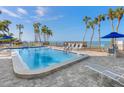 Inviting community pool with ocean views and ample lounge chairs at 4822 Ocean Blvd # 8B, Sarasota, FL 34242