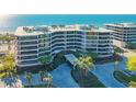 Stunning beachfront condo building with pool and lush landscaping at 565 Sanctuary Dr # A203, Longboat Key, FL 34228