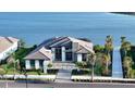 Waterfront property showcasing a contemporary home with a private walkway and lush landscaping at 1206 Blue Shell Loop, Sarasota, FL 34240