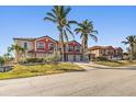 Two story building with attached garages and palm trees at 1323 Mediterranean Dr # 111, Punta Gorda, FL 33950