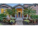 Welcoming entrance with palm trees, brick walkway, and well-lit facade at 1714 Irving St, Sarasota, FL 34236