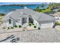 Waterfront home with metal roof, paver driveway, and boat dock at 2287 Bayshore Rd, Nokomis, FL 34275
