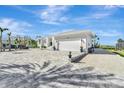 White house with gray paver driveway and attached garage at 2287 Bayshore Rd, Nokomis, FL 34275