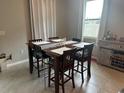 Dining area with dark brown table and chairs, adjacent to the kitchen at 2943 Greenleaf Ter, Parrish, FL 34219