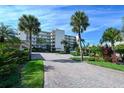 Front view of the building, showing landscaping and parking at 4825 Gulf Of Mexico Dr # 304, Longboat Key, FL 34228