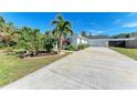 Long driveway leading to a white house with garage at 606 19Th W Ave, Palmetto, FL 34221
