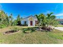 Landscaped yard with palm trees and a white house at 606 19Th W Ave, Palmetto, FL 34221