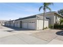Row of attached garages with white doors and light gray building exterior at 932 Capri Isles Blvd # 216, Venice, FL 34292