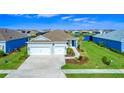 Single-story house with a two-car garage and a lake view at 14316 Skipping Stone Loop, Parrish, FL 34219
