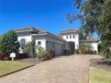 Two-story home with tile roof, three-car garage, and landscaped yard at 16907 Verona Place, Lakewood Ranch, FL 34202