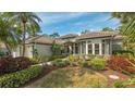 Well maintained house with attractive landscaping and a covered entryway at 1965 White Feather Ln, Nokomis, FL 34275
