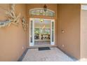 Open front door revealing a view into the interior living space at 2123 Calusa Lakes Blvd, Nokomis, FL 34275