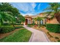 Landscaped walkway leading to the entrance of a charming house at 2123 Calusa Lakes Blvd, Nokomis, FL 34275