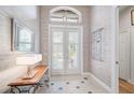 Bright entryway with double doors, wood-look floors, and neutral wall decor at 293 Turquoise Ln, Osprey, FL 34229