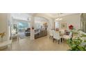 Bright dining area with a glass table and white chairs at 322 Siena Vista Pl, Sun City Center, FL 33573