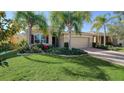 Well-maintained house with palm trees and a brick driveway at 322 Siena Vista Pl, Sun City Center, FL 33573