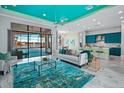 Open living space with teal accents, large windows, and modern furniture at 4779 Pastel Ct, Sarasota, FL 34240