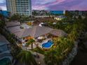 Aerial view of waterfront home with pool and lush landscaping at 4817 Ocean Blvd, Sarasota, FL 34242