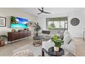 Bright living room featuring sectional sofa and large TV at 5107 Coral Reef Way, Bradenton, FL 34211