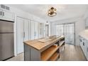 Modern kitchen with gray cabinets, a large island, and stainless steel appliances at 1007 Gulf N Dr # 106, Bradenton Beach, FL 34217
