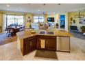Open kitchen features granite island, stainless steel appliances, and views to Gathering room at 1035 Bradberry Dr, Nokomis, FL 34275