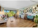 Living room with hardwood floors, eclectic decor and access to the patio at 2155 Wood St # B17, Sarasota, FL 34237