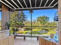 Relaxing screened patio with wooden furniture and lush garden views at 2155 Wood St # B17, Sarasota, FL 34237
