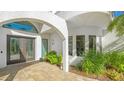 Modern double door entry with arched entryway and stone walkway at 269 Pine Ranch Trl, Osprey, FL 34229