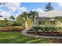 House exterior showcasing a walkway, landscaping, and palm trees at 310 Wexford Ter # 164, Venice, FL 34293