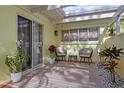 Cozy patio with seating area, plants, and stone accents at 310 Wexford Ter # 164, Venice, FL 34293