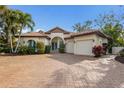 Lovely single-story home boasting a clay tile roof, lush landscaping, a paved driveway, and an attached two-car garage at 4946 Brywill Cir, Sarasota, FL 34234